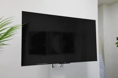 a flat screen tv hanging on a wall at Shinbashi Oliver in Tokyo