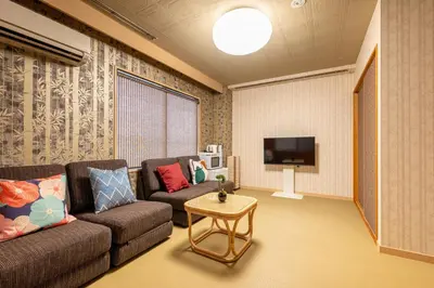 a living room with a couch and a tv at WA NO YADO-Asakusa Retreat 10 min walk from Asakusa Designer curated stylish room 3 in Tokyo