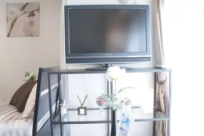 a flat screen tv sitting on top of a tv stand at #3 Tokyo Shinjuku Shibuya room in Tokyo