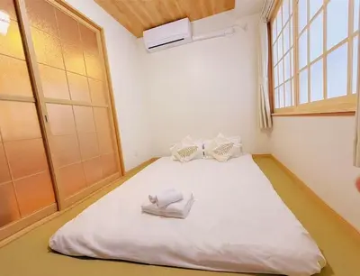 a large bed in a room with a window at Silvership Hotel 302 in Tokyo