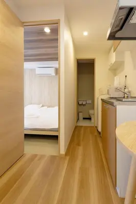 a small kitchen with a bed in a room at Silvership Hotel 302 in Tokyo