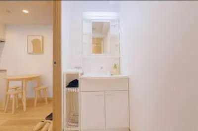 a white bathroom with a sink and a mirror at Silvership Hotel 302 in Tokyo