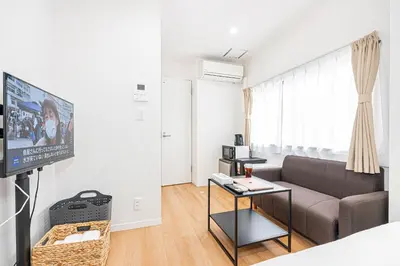 a living room with a couch and a tv at \u83ca\u5ddd\u99c5\u5f92\u6b69\u516d\u5206 Zaito Kiku House in Tokyo
