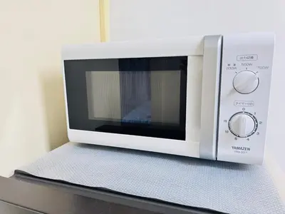 a microwave oven sitting on top of a counter at Shinagawa City \u834f\u539f201-SN0480 in Tokyo