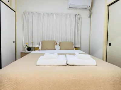 a bedroom with a large bed with towels on it at Shinagawa City \u834f\u539f201-SN0480 in Tokyo