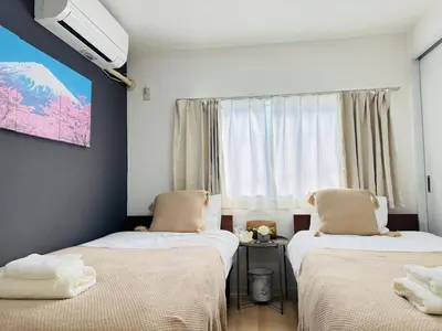two beds in a room with a window at Shinagawa City \u834f\u539f301-SN0481 in Tokyo