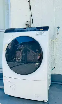 a white washing machine sitting next to a building at Shinagawa City \u834f\u539f301-SN0481 in Tokyo