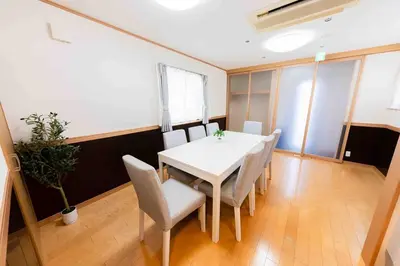 a dining room with a white table and chairs at SUA HOTEL Shinjuku Yochomachi in Tokyo