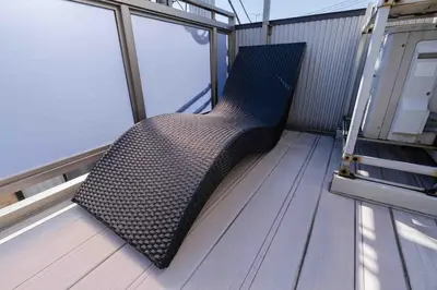 a black couch sitting on a balcony of a boat at SUA HOTEL Shinjuku Yochomachi in Tokyo