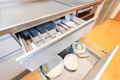 an open kitchen with white counters and chairs at SUA HOTEL Shinjuku Yochomachi in Tokyo