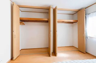 a room with two closet doors in a bedroom at SUA HOTEL Shinjuku Yochomachi in Tokyo