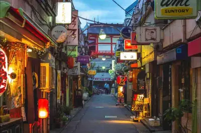 a city street with many shops and signs at SUA HOTEL Shinjuku Yochomachi in Tokyo