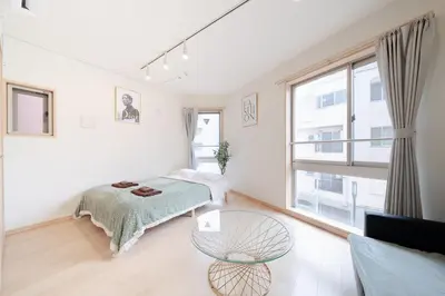 a bedroom with a bed and a glass table at SUA HOTEL Shinjuku in Tokyo