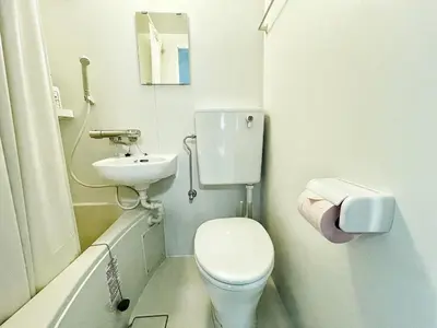 a small bathroom with a toilet and a sink at KYM Heights in Tokyo