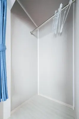 a closet with white walls and a blue curtain at JJ HOUSE Omori Heiwajima - Near Shinagawa Haneda Airport - Japanese Style Room - Floor Heating System in Tokyo