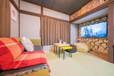 a hotel room with a bed and a tv at JJ HOUSE Omori Heiwajima - Near Shinagawa Haneda Airport - Japanese Style Room - Floor Heating System in Tokyo