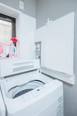 a white washer and dryer in a room at JJ HOUSE Omori Heiwajima - Near Shinagawa Haneda Airport - Japanese Style Room - Floor Heating System in Tokyo