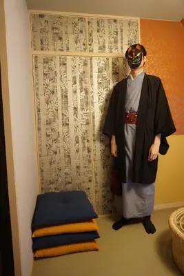 a man in a kimono standing next to a window at WA NO YADO-Asakusa Retreat 10 min walk from Asakusa Designer curated stylish room 4 in Tokyo