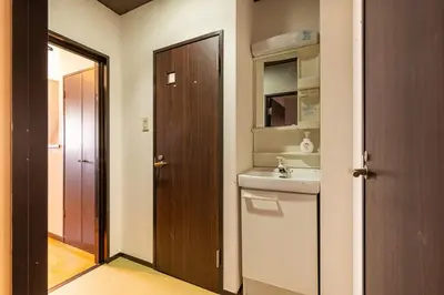 a bathroom with a sink and a mirror and a door at WA NO YADO-Asakusa Retreat 10 min walk from Asakusa Designer curated stylish room 4 in Tokyo