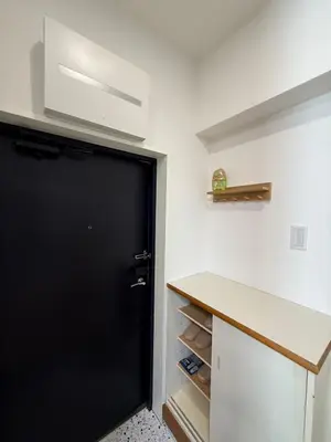 a black door in a white kitchen with a counter at The Waseda Villa \u30f4\u30a3\u30e9\u65e9\u7a32\u7530 in Tokyo