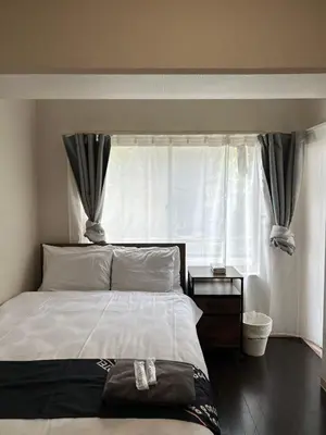 a bedroom with a large bed and a window at The Waseda Villa \u30f4\u30a3\u30e9\u65e9\u7a32\u7530 in Tokyo