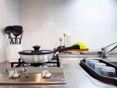 a kitchen with a pot on a stove with utensils at RARE-EBISU BREEZE Apartment in Tokyo