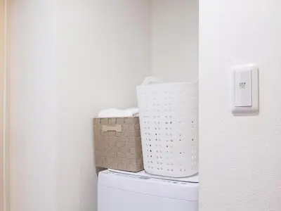 a bathroom with a basket on top of a toilet at RARE-EBISU BREEZE Apartment in Tokyo