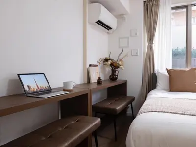 a bedroom with a desk with a laptop on it at RARE-EBISU BREEZE Apartment in Tokyo