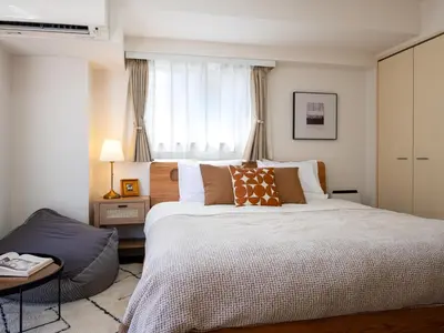 a bedroom with a large bed and a window at RARE-EBISU BREEZE Apartment in Tokyo