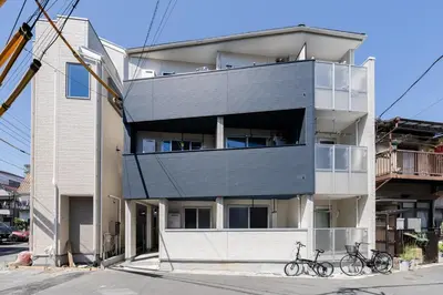 a building with two bikes parked in front of it at Cheerful Kanegafuchi in Tokyo