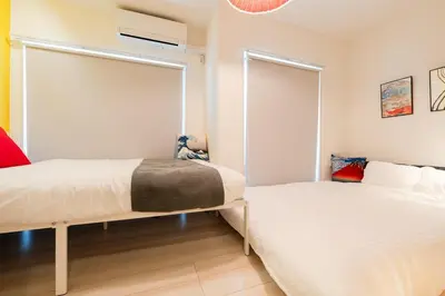 a bedroom with two beds and a window at Cheerful Kanegafuchi in Tokyo