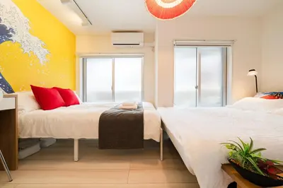 a bedroom with two beds and a window at Cheerful Kanegafuchi in Tokyo