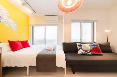 a bedroom with a bed and a couch at Cheerful Kanegafuchi in Tokyo