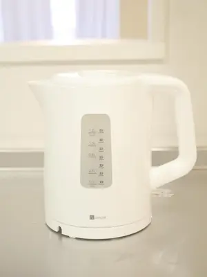 a white toaster sitting on top of a counter at 9Stay\u4e0a\u91ce\u5165\u8c37 in Tokyo