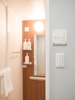 a bathroom with a mirror and a sink at 9Stay\u4e0a\u91ce\u5165\u8c37 in Tokyo