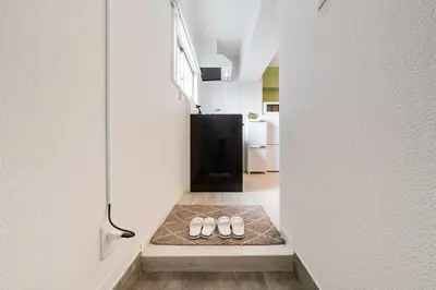 a pair of shoes sitting on a floor in a hallway at Cheerful Takadanobaba in Tokyo