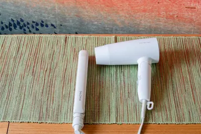 two white wii controllers sitting on a rug at Cheerful Takadanobaba in Tokyo