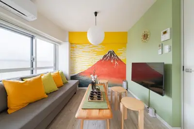 a living room with a couch and a table at Cheerful Takadanobaba in Tokyo