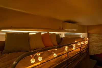 a couch with lights on it in a room at Cheerful Takadanobaba in Tokyo