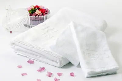 a white towel and some pink hearts on a table at Keio Presso Inn Ikebukuro in Tokyo
