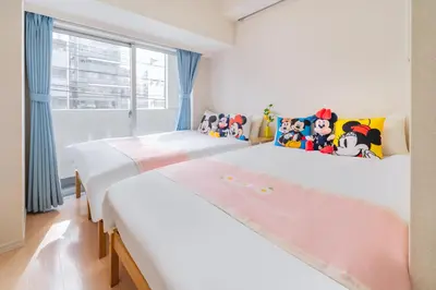 two twin beds in a room with a window at 202Room, 5 mins walk from JR Kinshicho North Exit!Near Asakusa & Sky Tree!! The house is on the 2th floor with an elevator, convenient transportation There is a balcony and the room is soundproofed in Tokyo