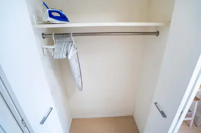 a walk in closet with white walls and wooden floors at 202Room, 5 mins walk from JR Kinshicho North Exit!Near Asakusa & Sky Tree!! The house is on the 2th floor with an elevator, convenient transportation There is a balcony and the room is soundproofed in Tokyo