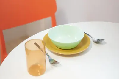 a bowl and a plate on a white table at Tierra Mukojima in Tokyo