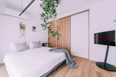a bedroom with a bed and a flat screen tv at Showa Bloom Shinjuku 3 in Tokyo