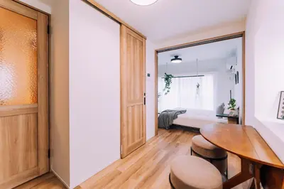a bedroom with a bed and a table and chairs at Showa Bloom Shinjuku 3 in Tokyo