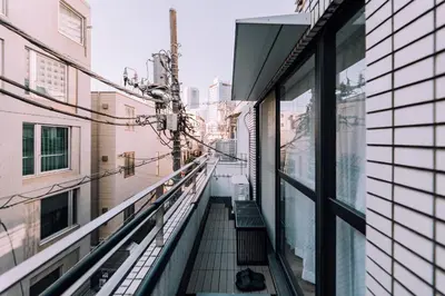 a balcony with a bench on the side of a building at Showa Bloom Shinjuku 3 in Tokyo