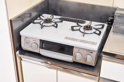 a white stove top oven in a kitchen at Hatagaya Hotel in Tokyo