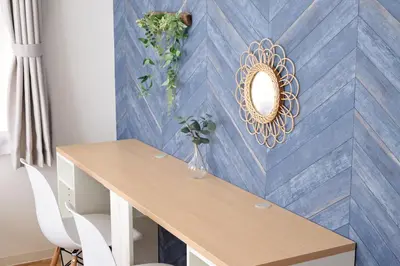 a dining room with a table and a blue wall at Hatagaya Hotel in Tokyo