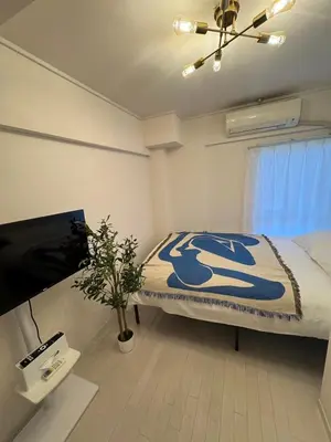 a bedroom with a bed and a tv in it at -Katsura 207- 4 mins to Okubo Station in Tokyo