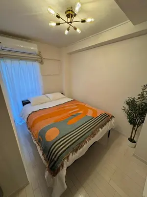 a bedroom with a bed and a ceiling fan at -Katsura 207- 4 mins to Okubo Station in Tokyo